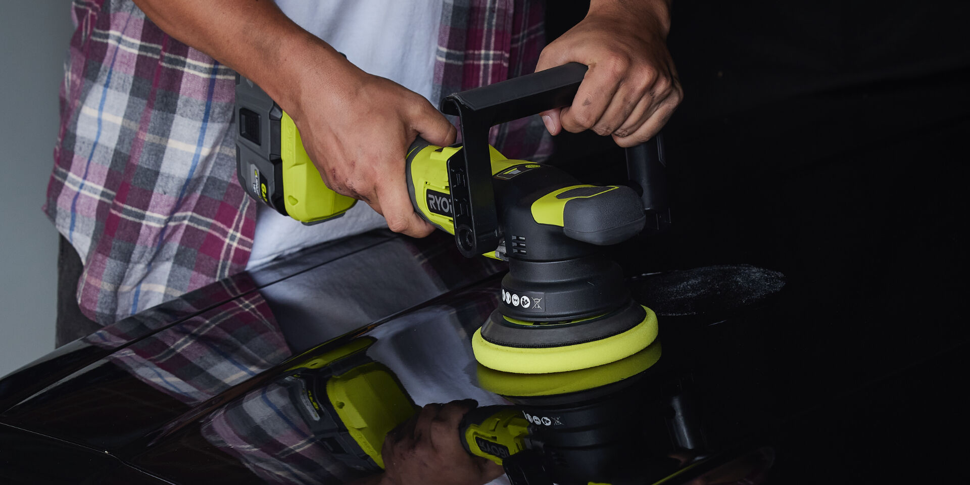 Man uses a Ryobi buffer to polish his car